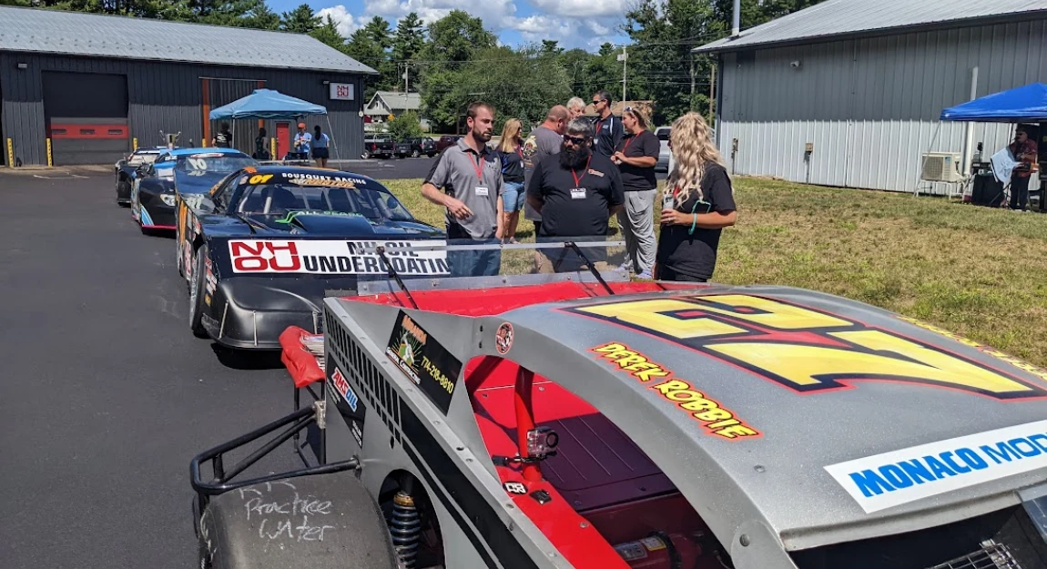 Derek Robbie DDR Motorsports race car with partner sponsor logos at the track.